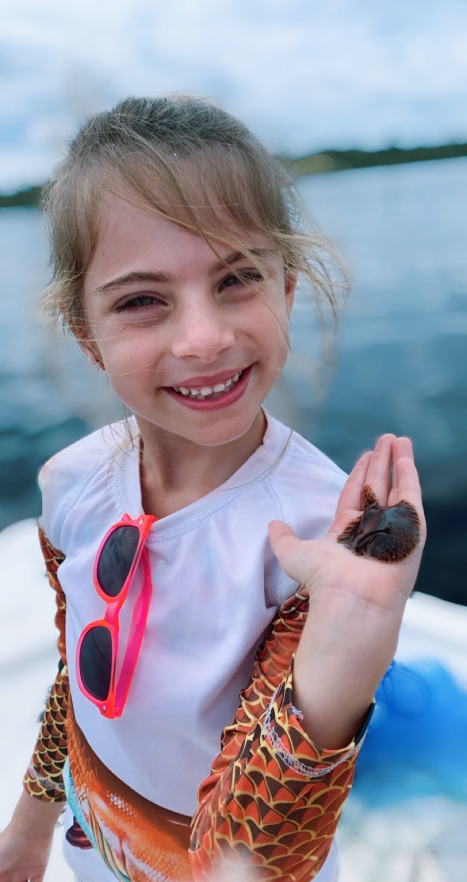 little girl holding a flounder fish. Little girl on a boat in the St. John's River in Palatka, Florida holding a flounder.